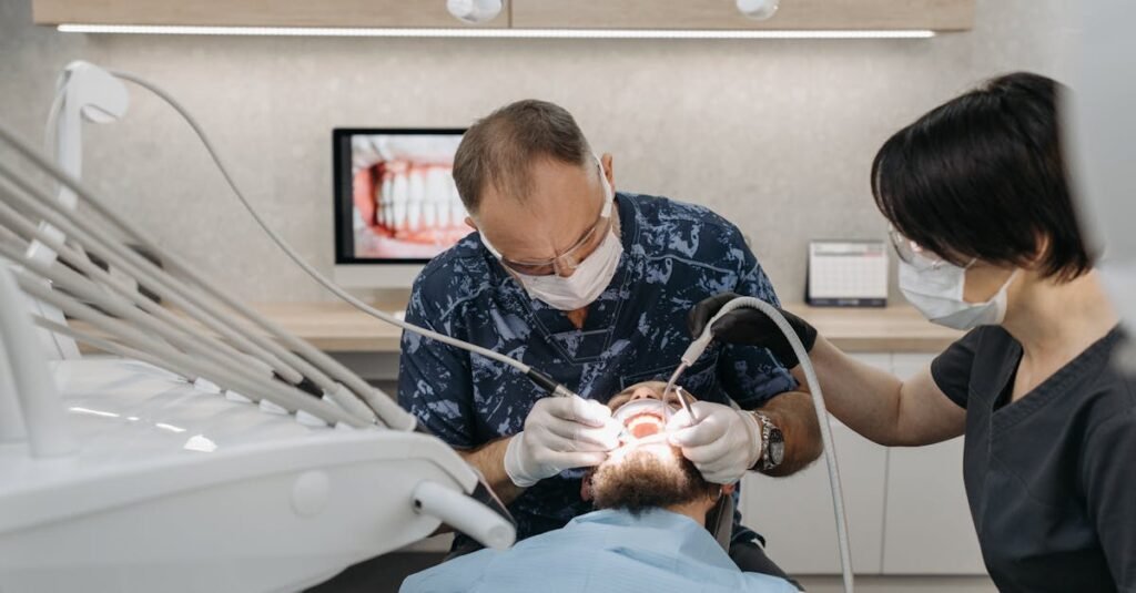 dentist and assistant performing a dental procedure on a patient in a modern clinic